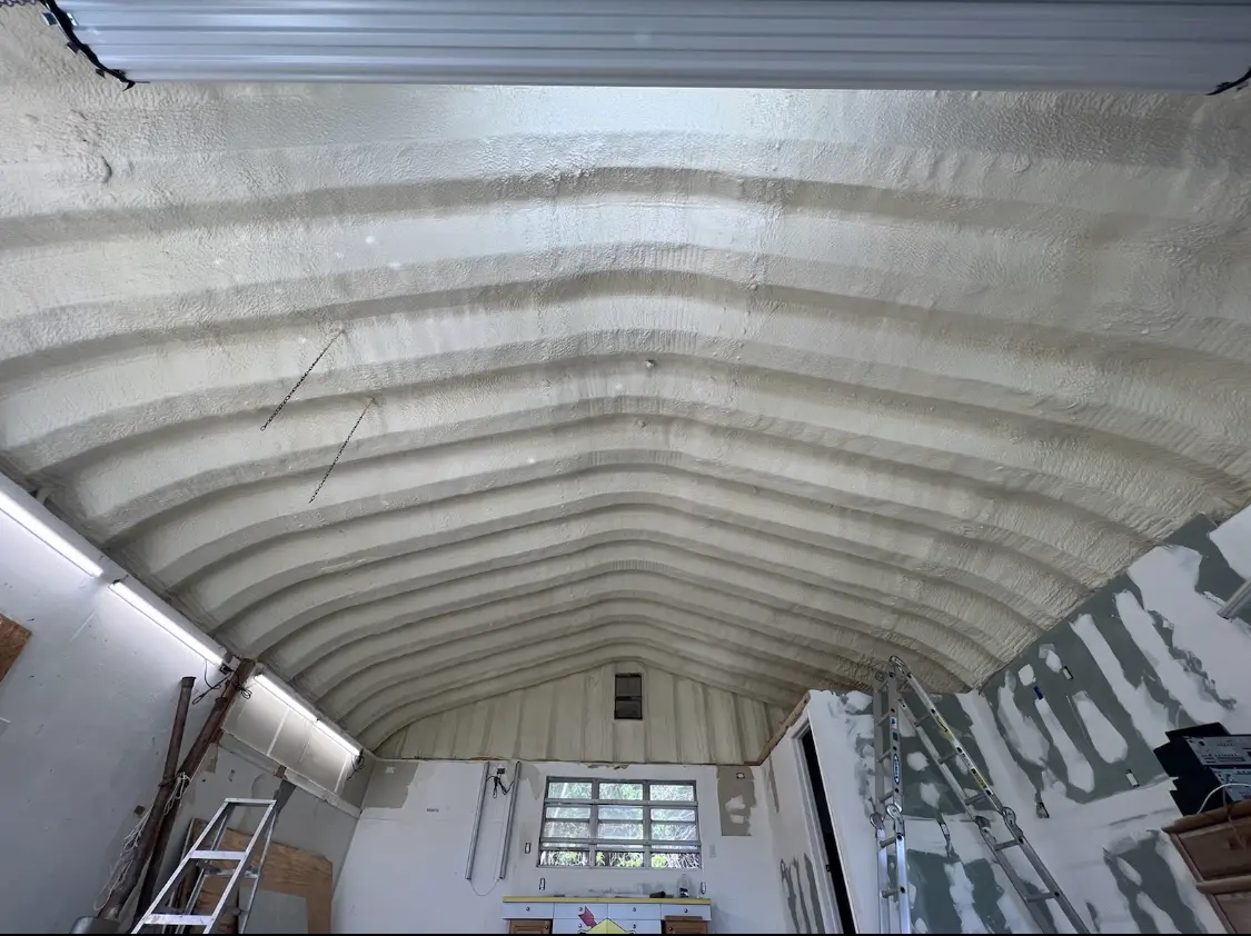 Spray polyurethane foam applied to the underside of a metal roof deck in Potomac